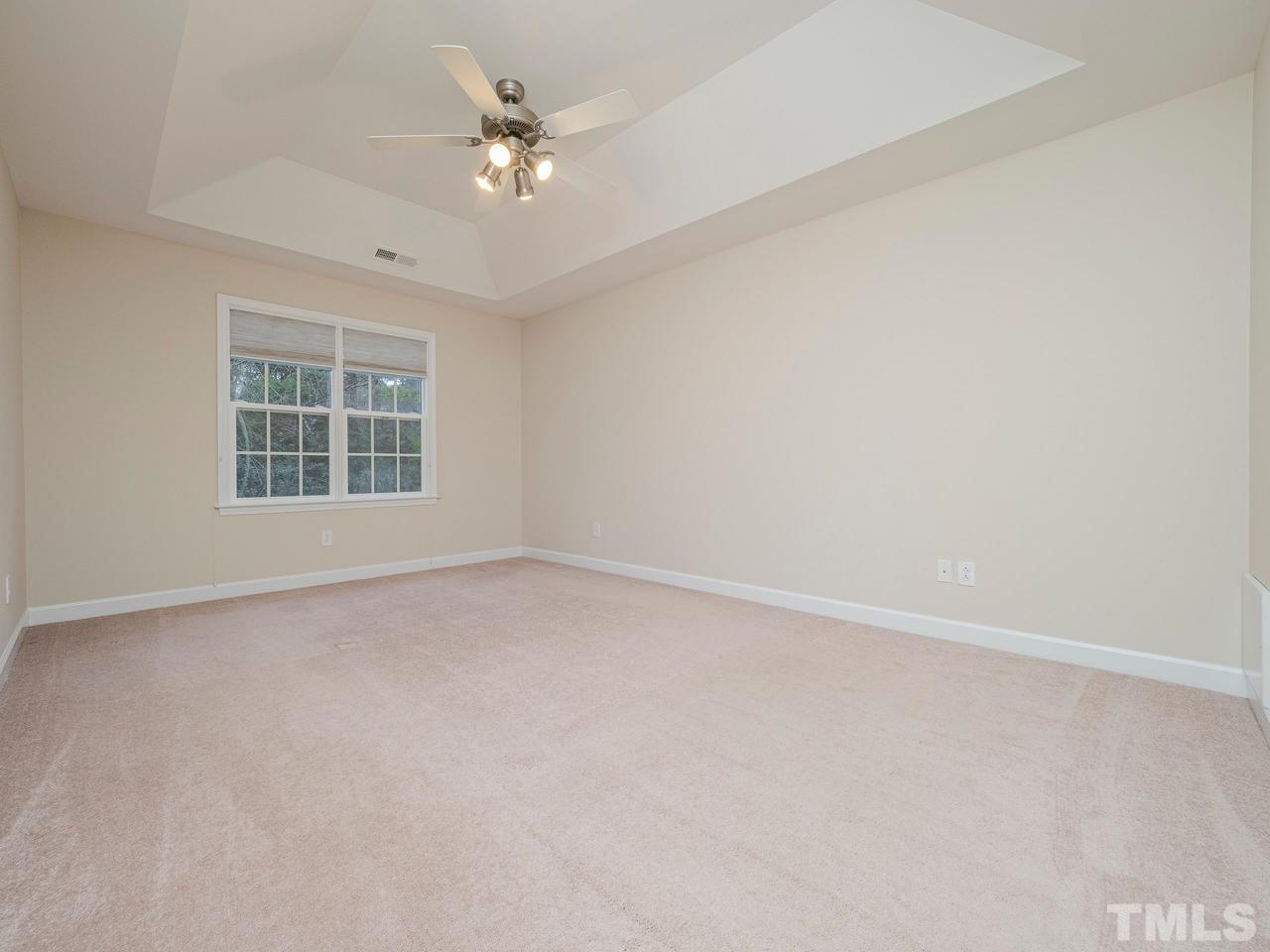 6025 Four Townes Lane Raleigh, NC 27616 - Photo 16 of 24 an empty room with a window and a ceiling fan