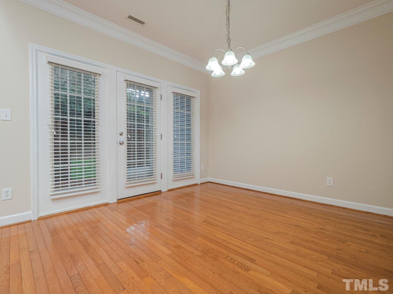 6025 Four Townes Lane Raleigh, NC 27616 - Photo 10 of 24 a view of an empty room with wooden floor and a window