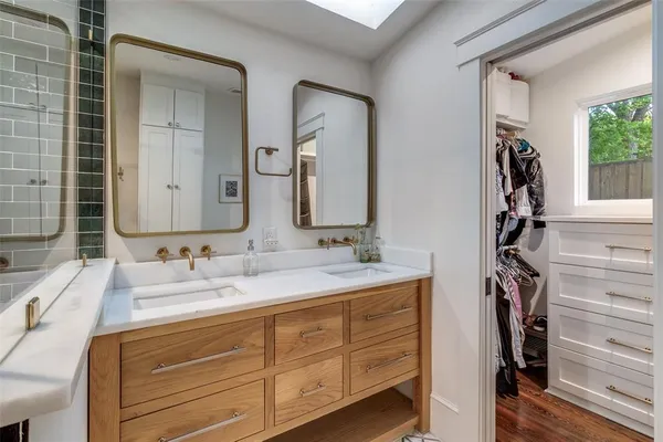 a bathroom with a double vanity sink and mirror