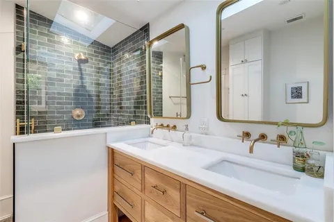 a bathroom with a double vanity sink mirror and double