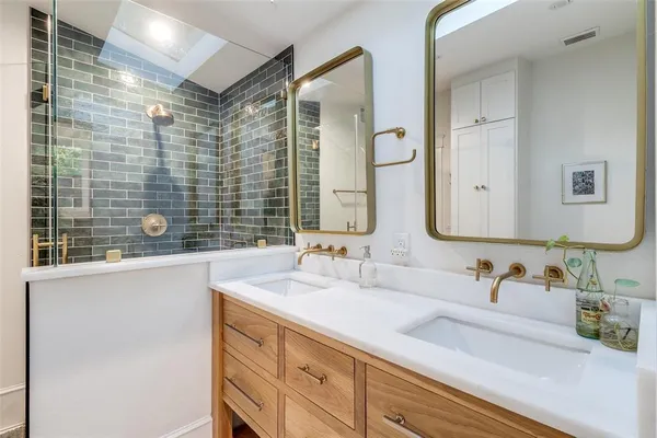 a bathroom with a double vanity sink mirror and double