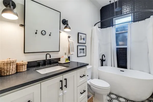 a bathroom with a double vanity sink toilet and shower
