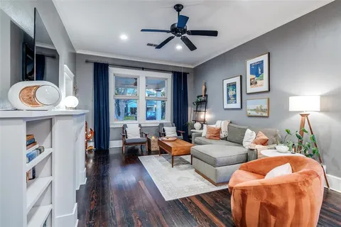 a living room with furniture a ceiling fan and a rug