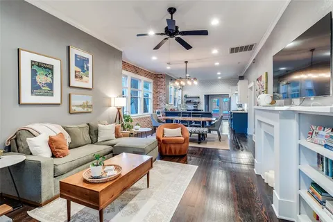 a living room with furniture kitchen view and a chandelier