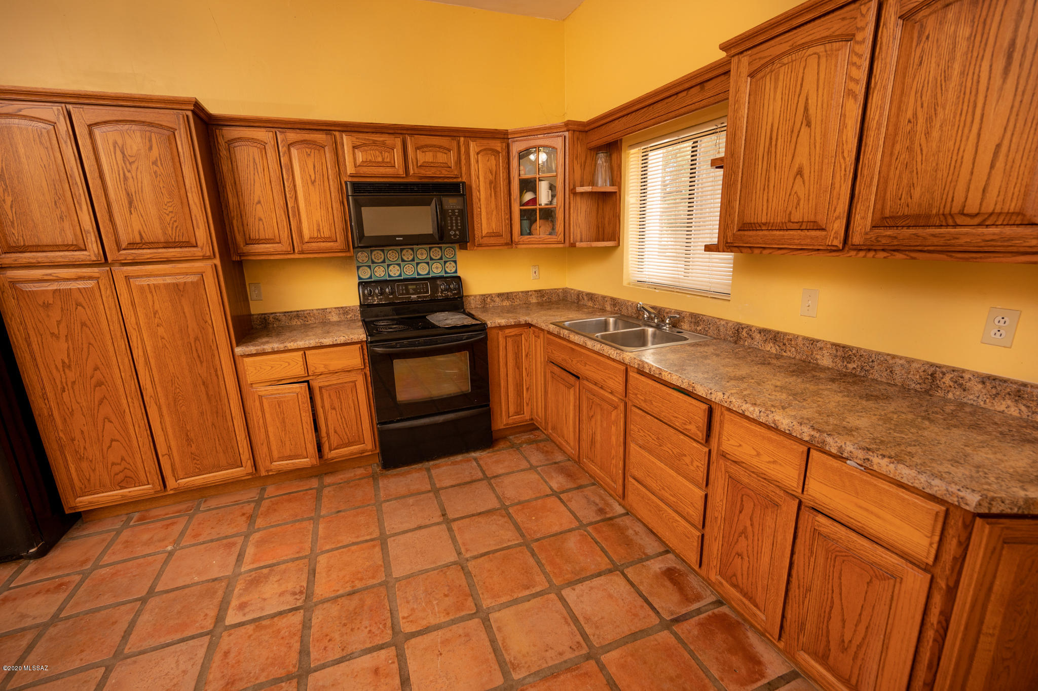 964 Calle Robalo Rio Rico, AZ 85648 - Photo 20 of 35 a kitchen with stainless steel appliances granite countertop a stove a sink and a refrigerator