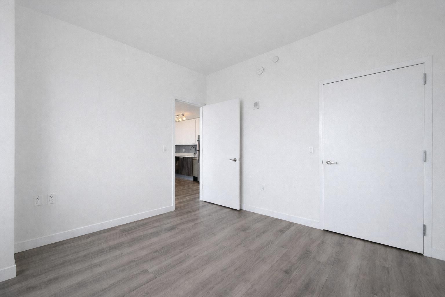 1524 Sheepshead Bay Road, Unit 18J Brooklyn, NY 11235 - Photo 6 of 25 a view of an empty room with wooden floor