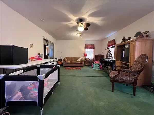 a living room with furniture gym equipment and a flat screen tv