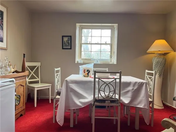 a spacious bedroom with a bed and a chandelier