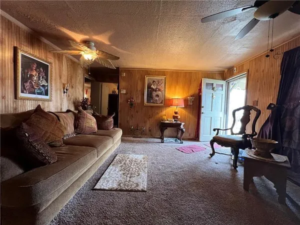 a living room with furniture gym equipment and a large window