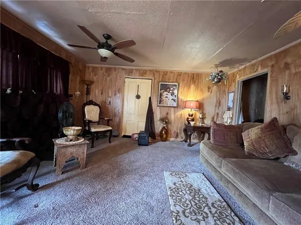 a living room with furniture a clock and a rug