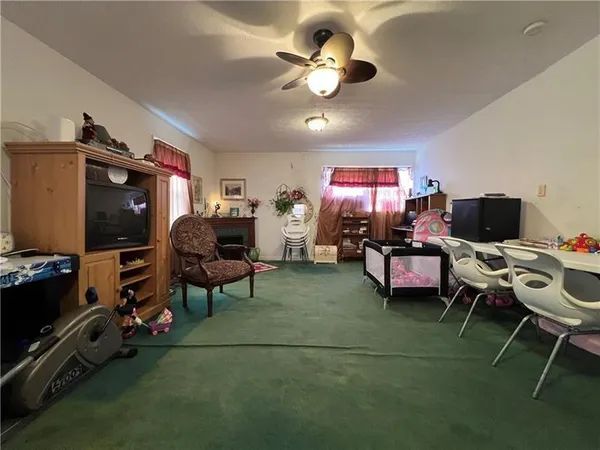 a view of a workspace with furniture and a flat screen tv