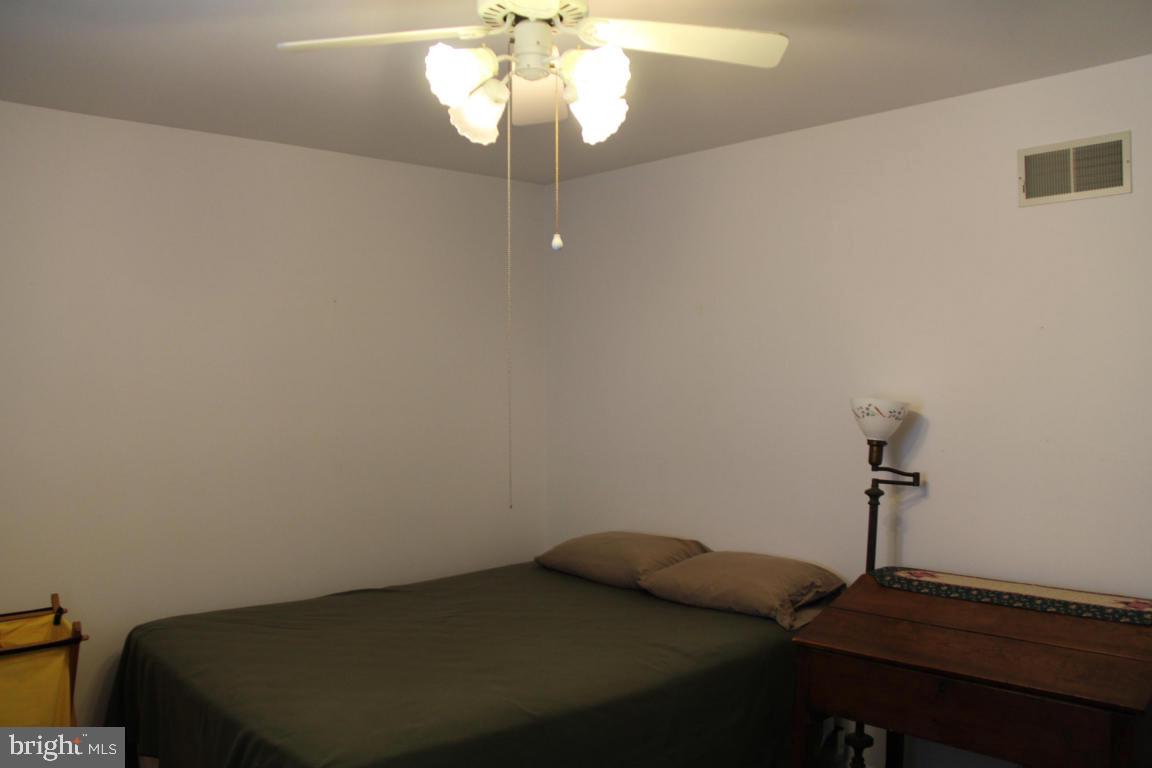 3 Warren Circle Lititz, PA 17543 - Photo 16 of 27 a bedroom with a bed and a chandelier
