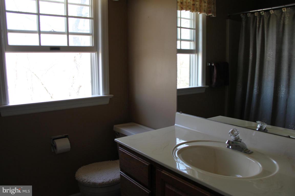 3 Warren Circle Lititz, PA 17543 - Photo 27 of 27 a bathroom with a sink toilet a mirror and window