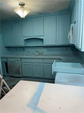 a kitchen with a cabinets and chandelier