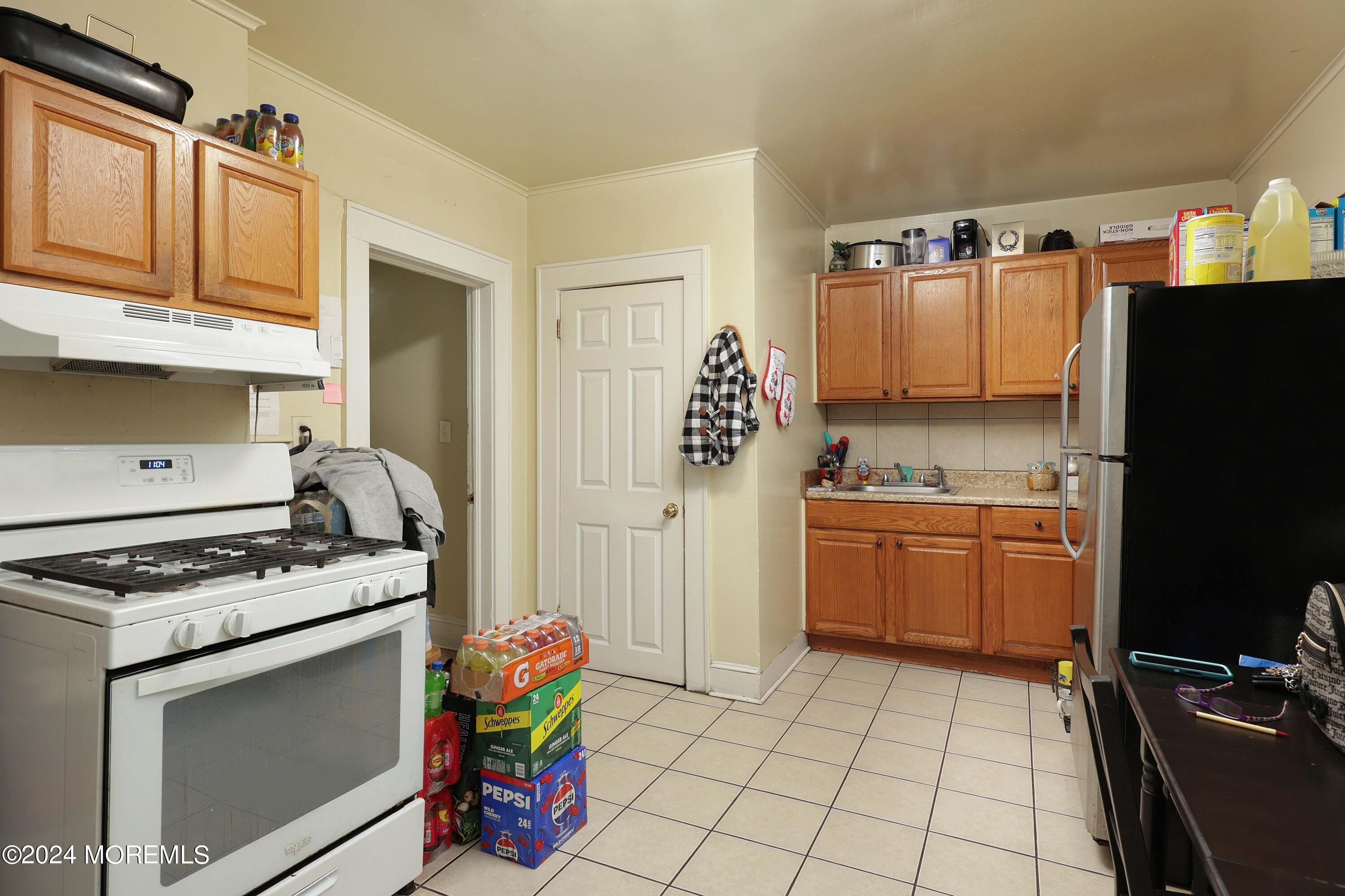 a kitchen with granite countertop a stove and a refrigerator