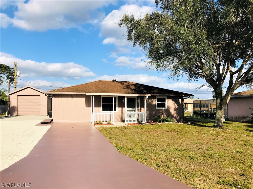 18449 Flamingo Road Fort Myers, FL 33967 - Photo 1 of 20 a front view of a house with a yard