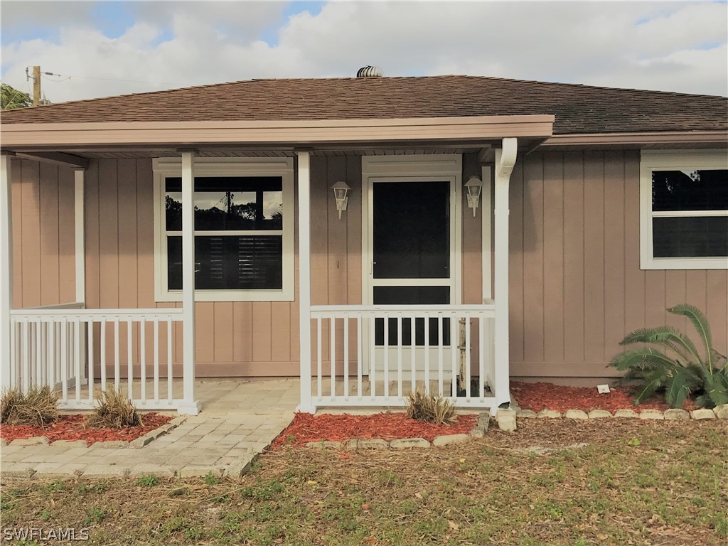 18449 Flamingo Road Fort Myers, FL 33967 - Photo 2 of 20 a front view of a house with a yard