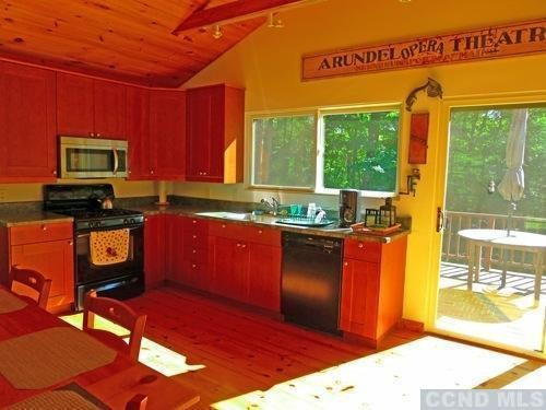 161 Stagecoach Road Hillsdale, NY 12529 - Photo 4 of 10 a kitchen with stainless steel appliances kitchen island granite countertop a refrigerator stove and sink