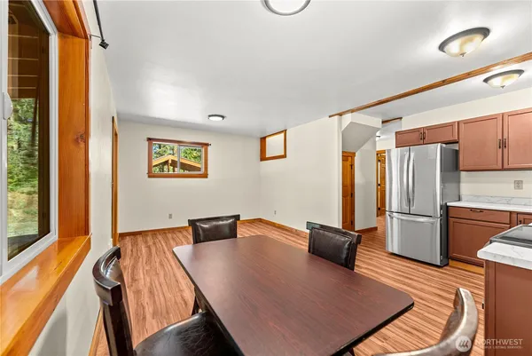 a view of a kitchen with wooden floor and a cabinet