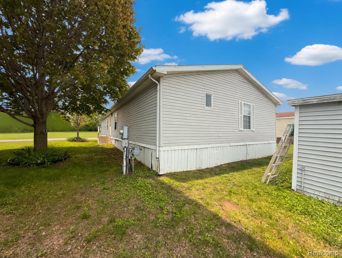 6988 McKean Road Ypsilanti, MI 48197 - Photo 30 of 31 View of property exterior featuring a yard