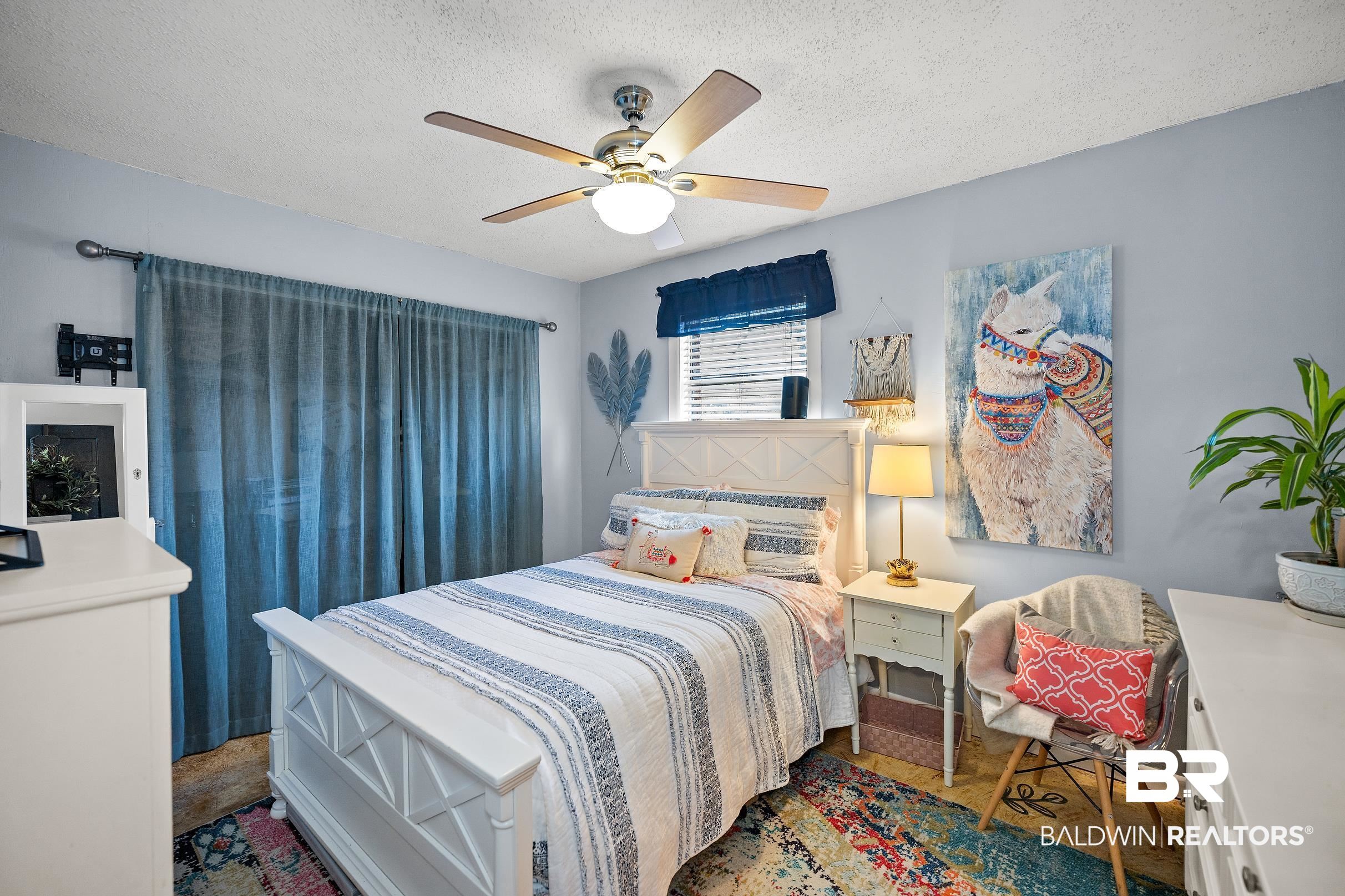 110 Sam Jones Road Atmore, AL 36502 - Photo 24 of 47 Bedroom featuring a textured ceiling and a ceiling fan