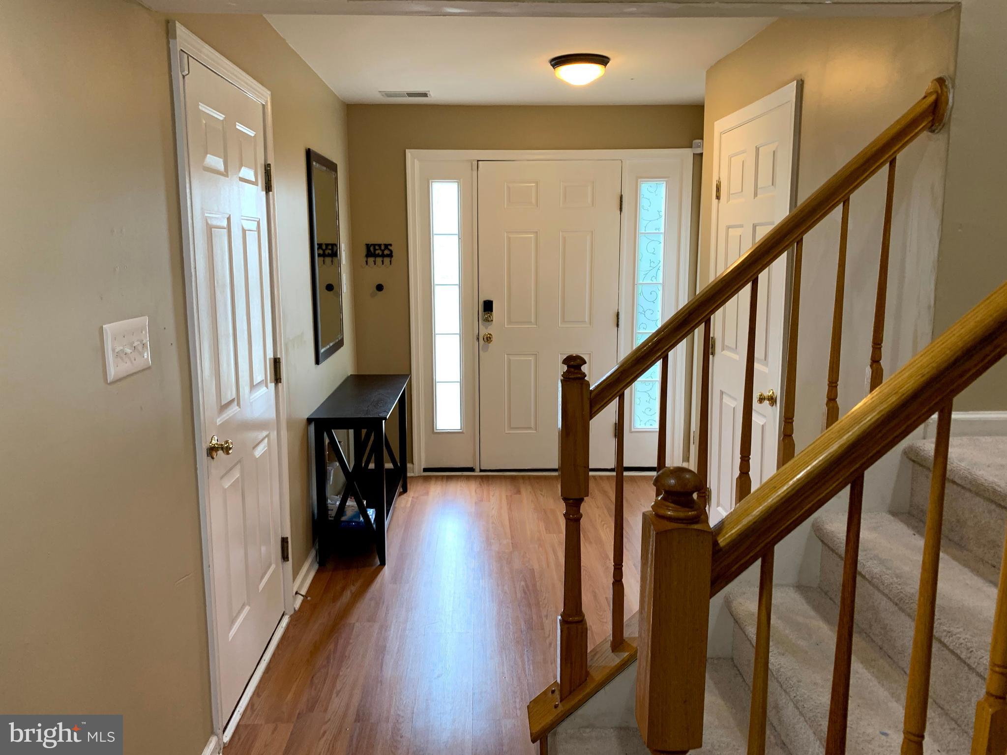 79 Millstream Road Pine Hill, NJ 08021 - Photo 3 of 43 a view of hallway with wooden floor and stairs