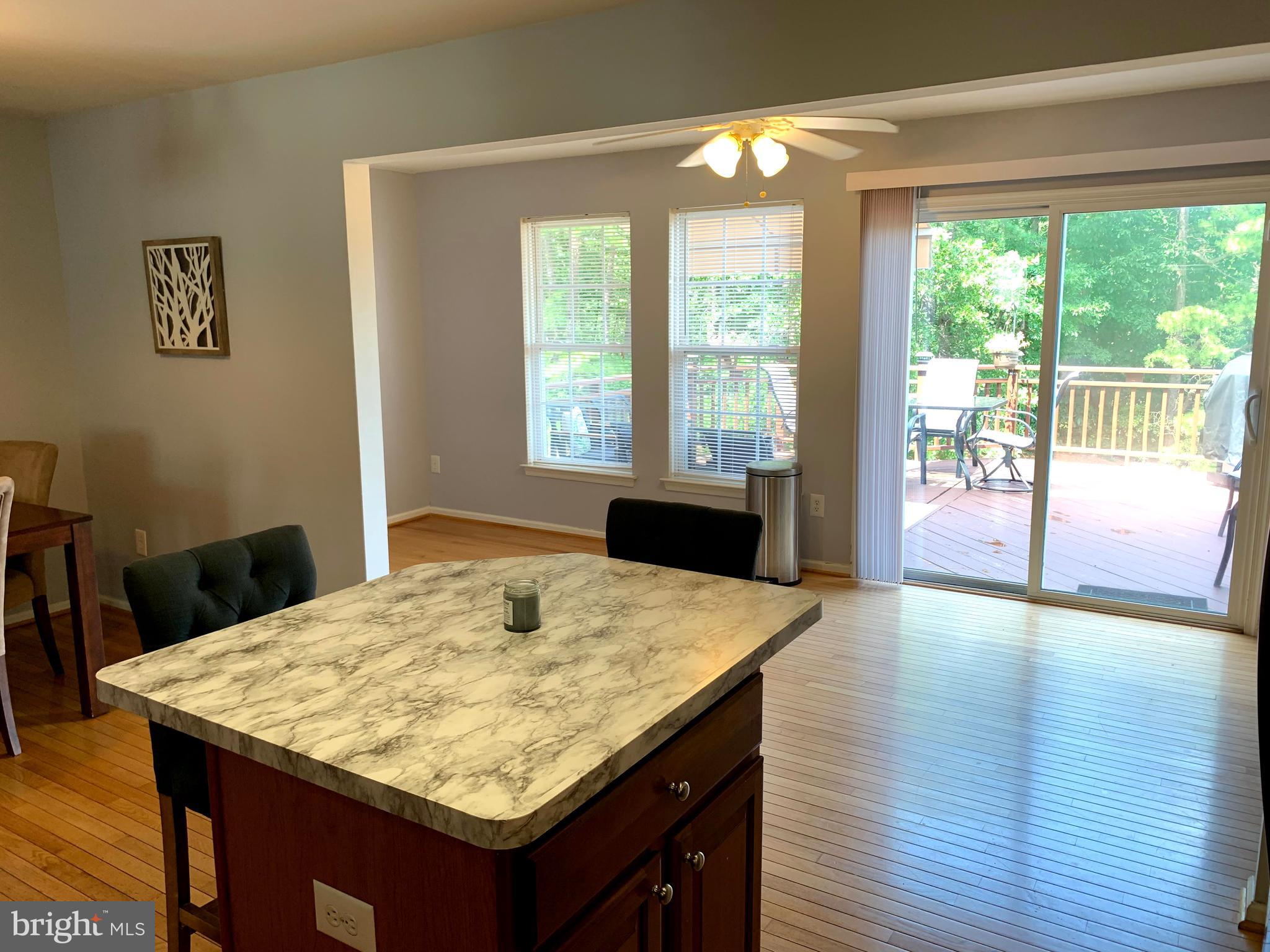 79 Millstream Road Pine Hill, NJ 08021 - Photo 22 of 43 a kitchen with kitchen island a large window appliances and living room