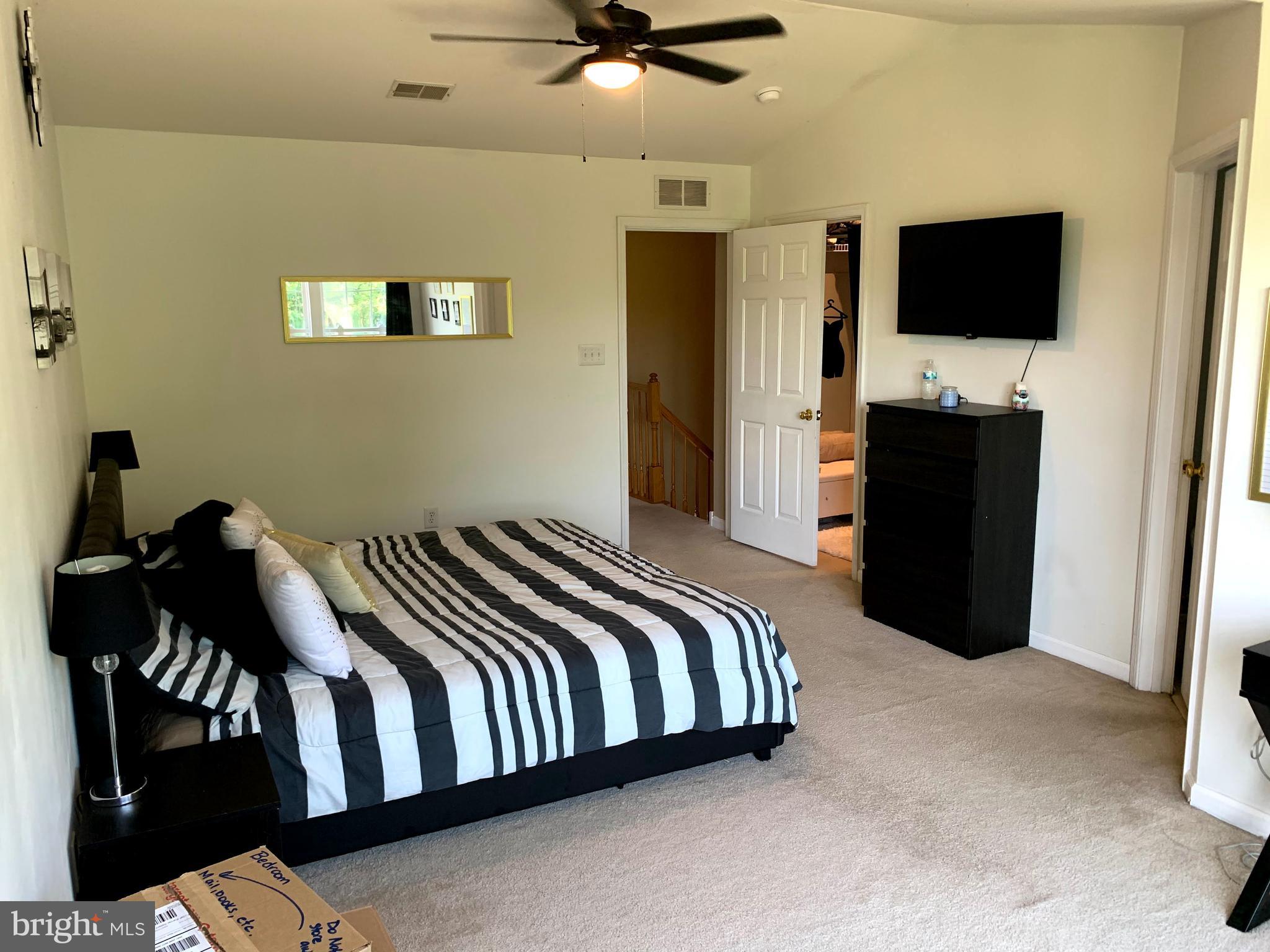 79 Millstream Road Pine Hill, NJ 08021 - Photo 40 of 43 a bedroom with a bed and a flat tv screen on the wall