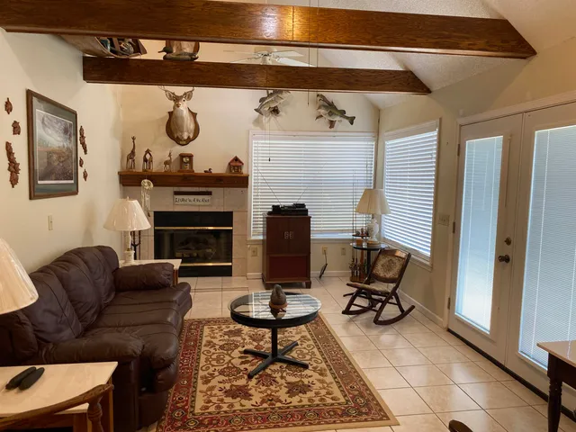 a living room with furniture and a piano