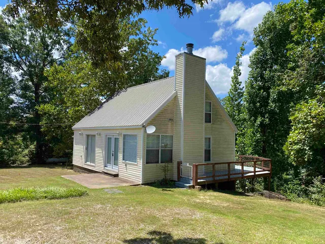 a view of a house with backyard porch and sitting area