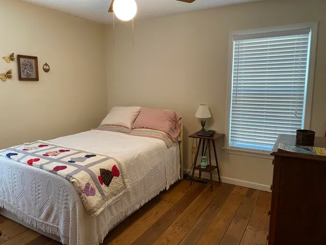 a bedroom with a bed and a dresser