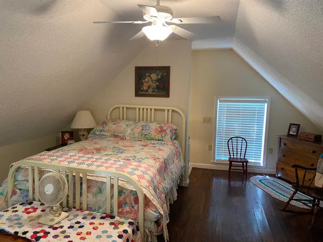 a view of a livingroom with furniture hardwood floor and a bathroom