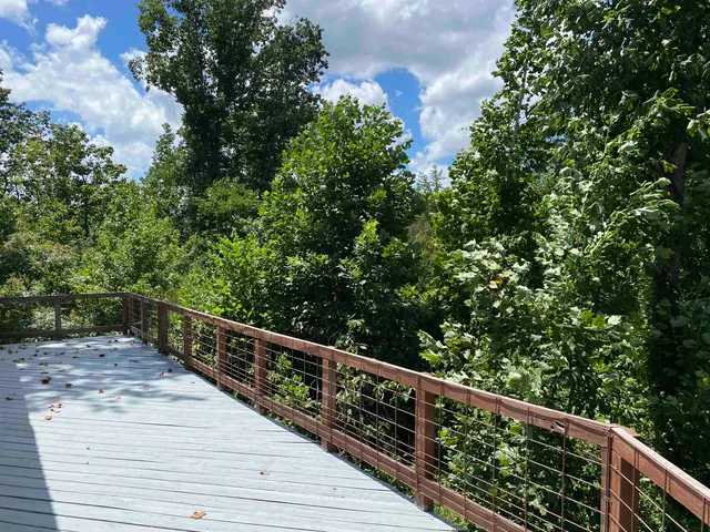 a balcony with trees in front of it