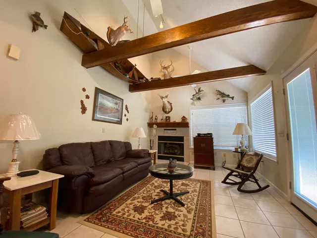 a living room with furniture a rug and a table