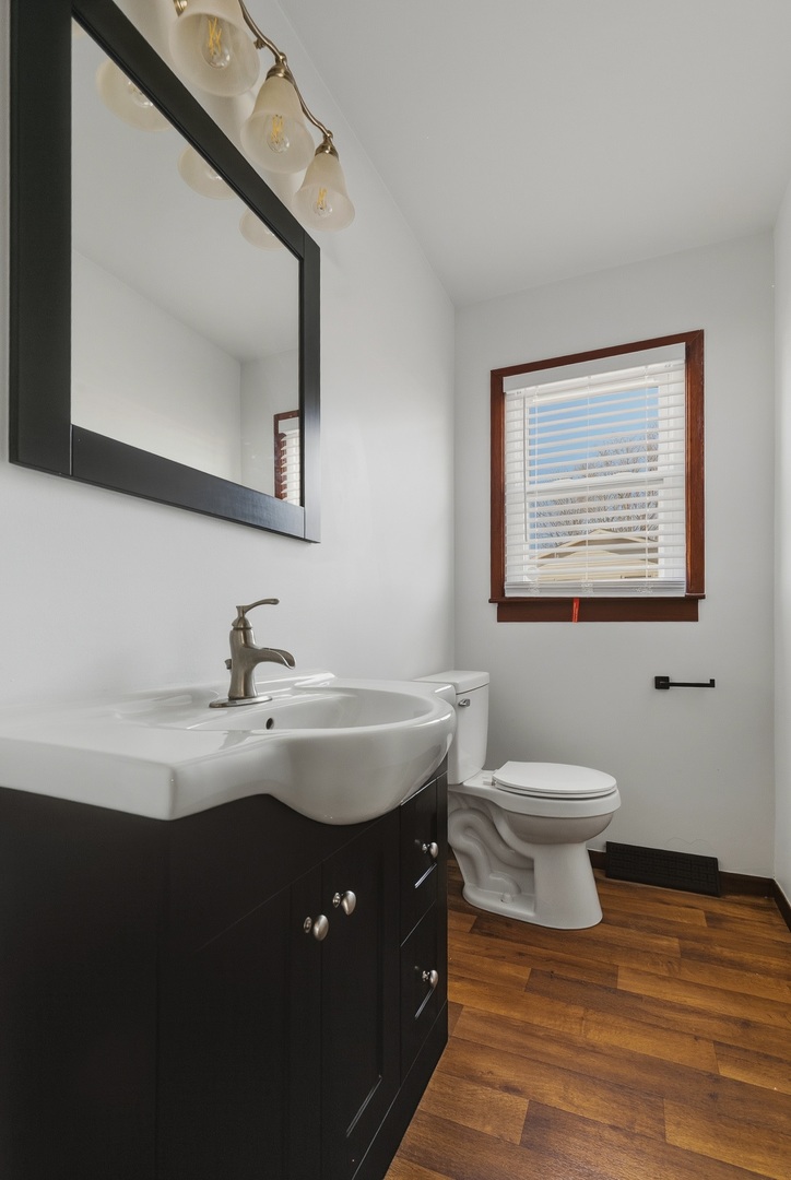 11622 27th Street West Milan, IL 61264 - Photo 17 of 49 a bathroom with a toilet sink and mirror