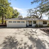 a view of house with a yard