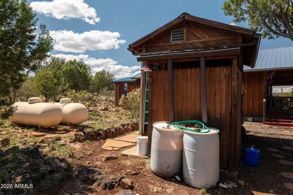 a backyard of a house with lots of green space and fountain