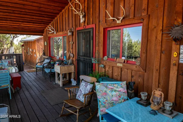 a kitchen with kitchen island granite countertop a stove top oven a sink a dining table and chairs