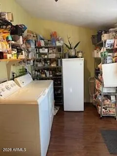 a view of a bedroom with wooden floor and a window
