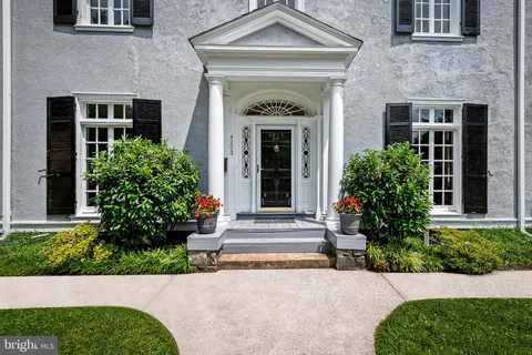 a front view of a house with plants