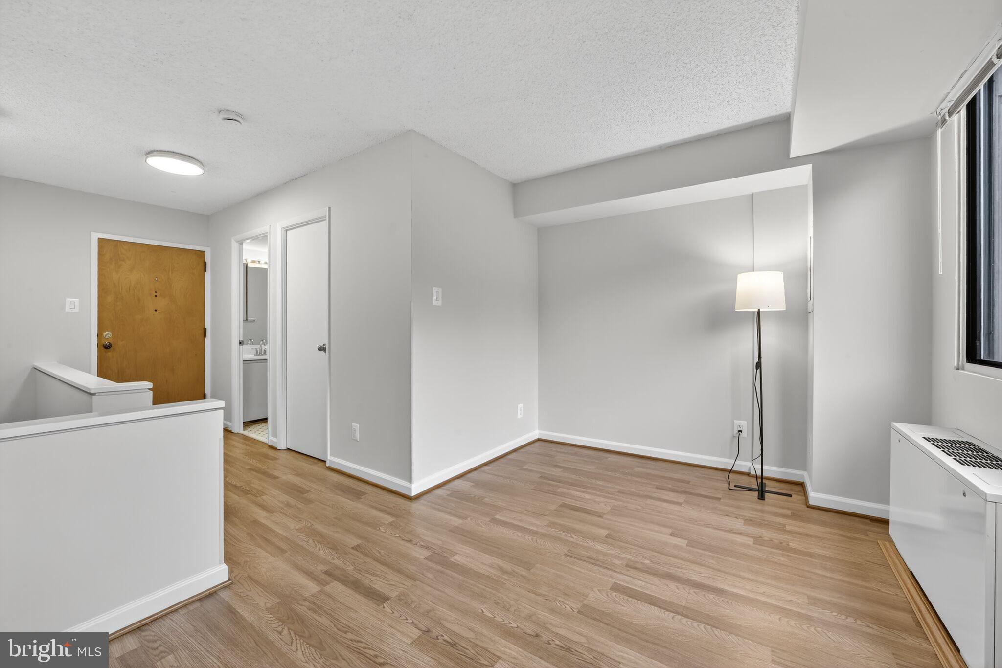 a view of a room with wooden floor and cabinet