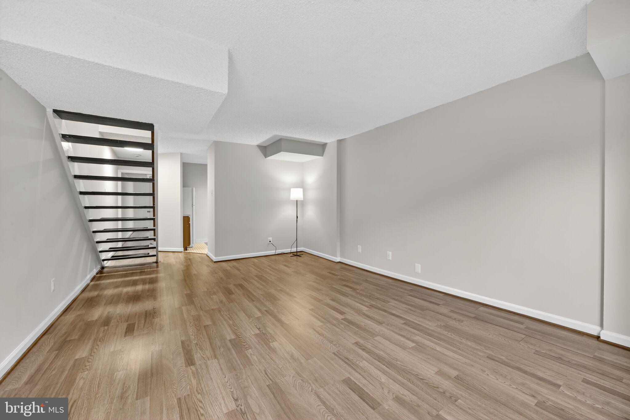 1245 13th Street Northwest, Unit 304 Washington, DC 20005 - Photo 11 of 43 wooden floor in an empty room with a window
