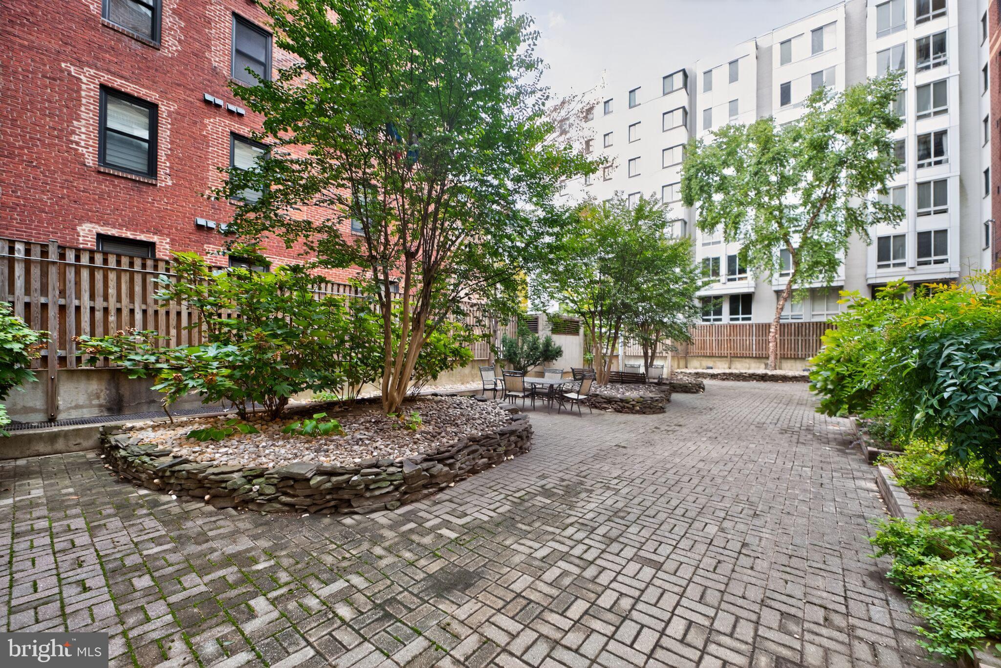 1245 13th Street Northwest, Unit 304 Washington, DC 20005 - Photo 26 of 43 a view of a street with a bench in front of it