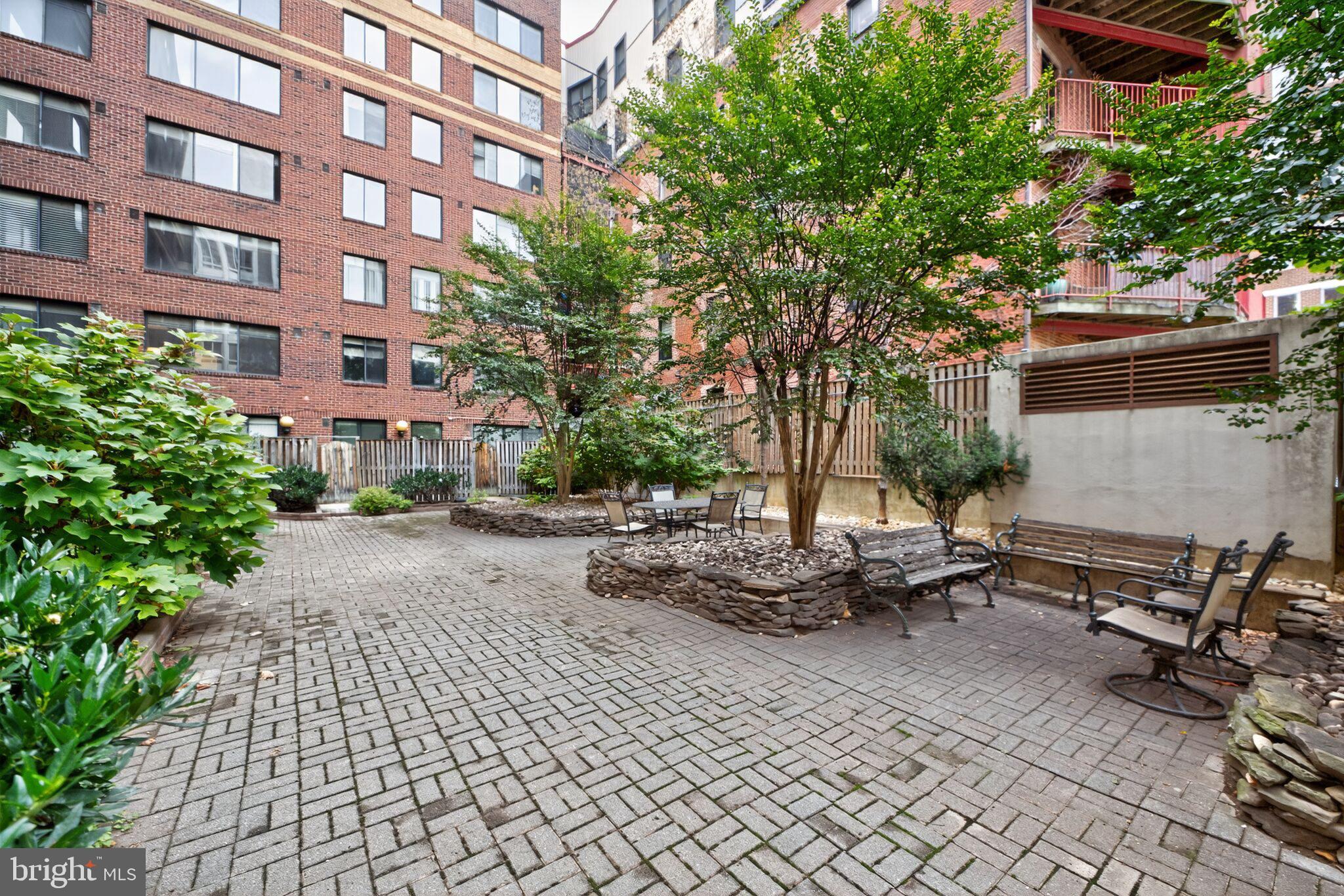 1245 13th Street Northwest, Unit 304 Washington, DC 20005 - Photo 27 of 43 a view of a patio with table and chairs and potted plants