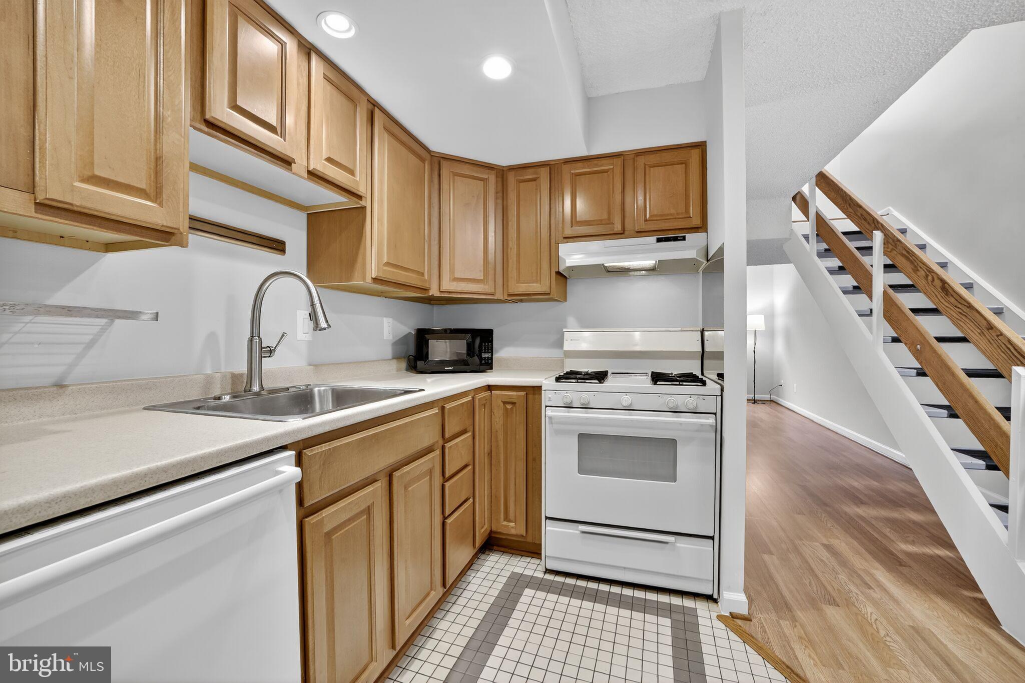 1245 13th Street Northwest, Unit 304 Washington, DC 20005 - Photo 6 of 43 a kitchen with a sink cabinets and appliances