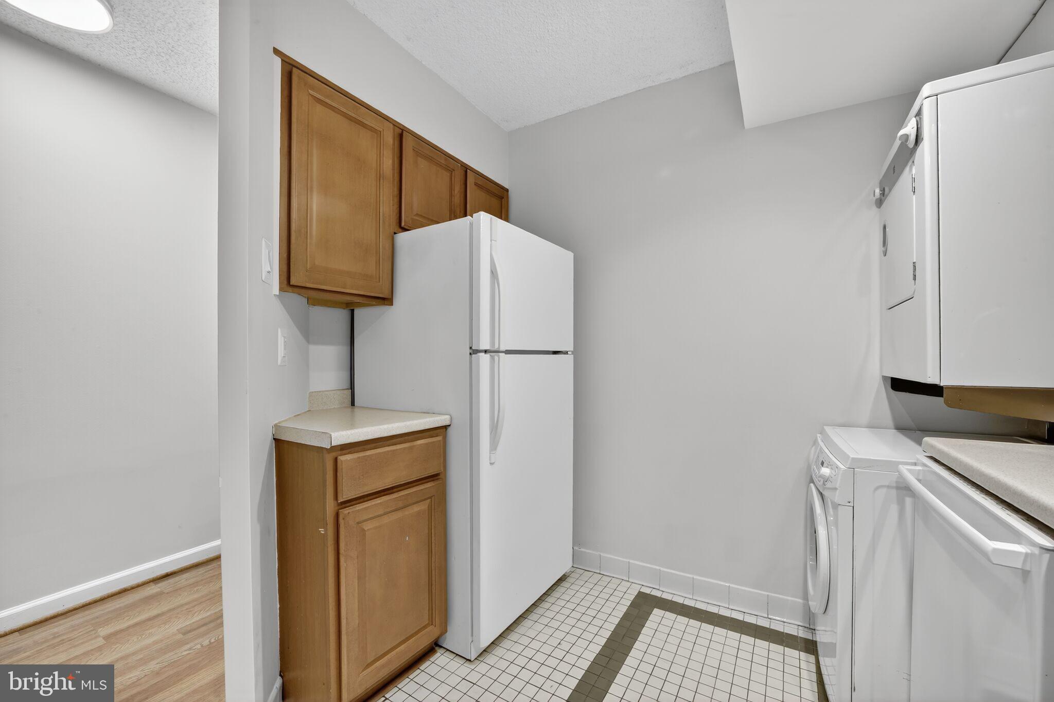 1245 13th Street Northwest, Unit 304 Washington, DC 20005 - Photo 7 of 43 a view of a kitchen with washer and dryer