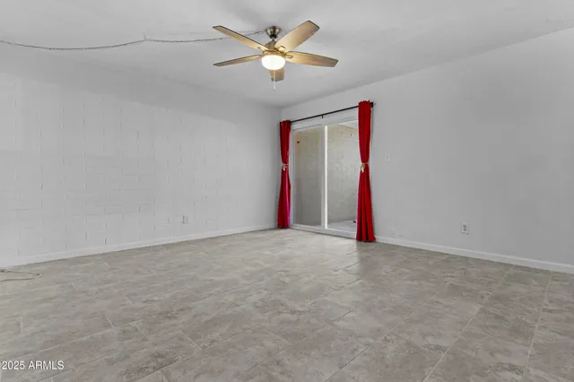 a view of a room with a ceiling fan