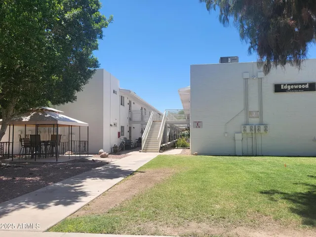 a view of a yard with plants and trees