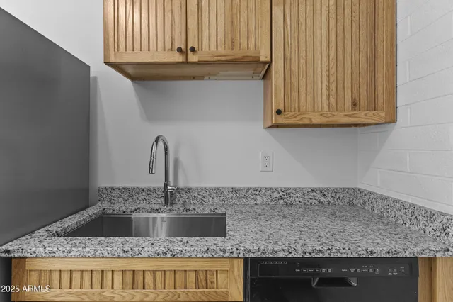 a kitchen with granite countertop a sink and granite counter tops