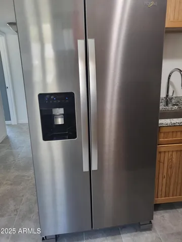 a view of a room with a ceiling fan and a wooden floor